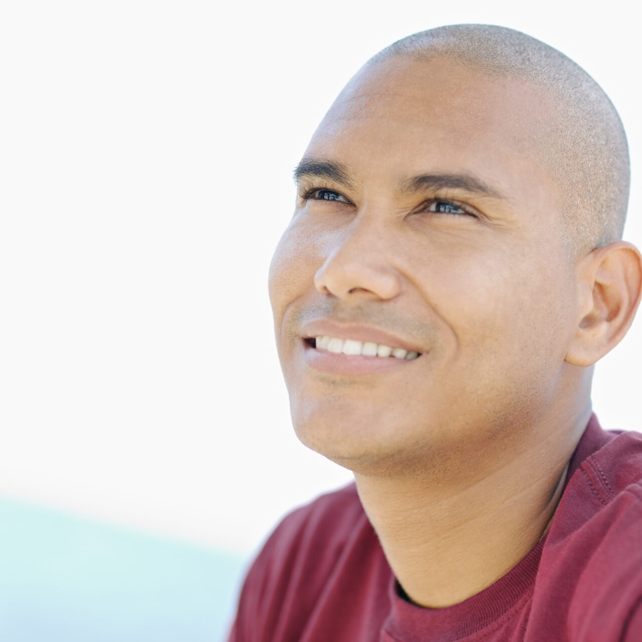 Portrait,Of,Young,Hispanic,Guy,With,Shaved,Head,Looking,Up